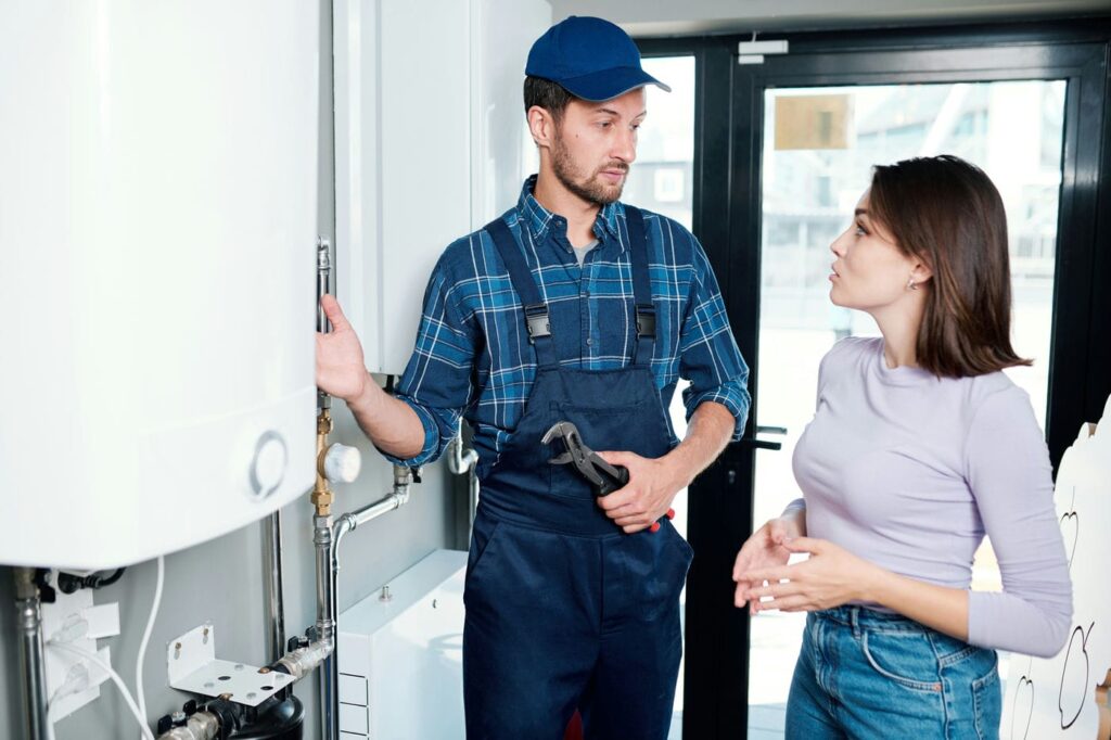 hvac contractor explaining to client how her boiler works
